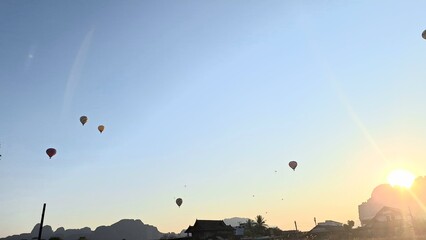 hot air balloon flying over the sunset