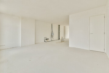 An empty minimalist interior space featuring white walls and a simple design, creating a calm and serene atmosphere ready for decoration.