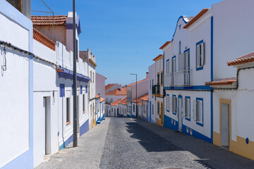Obraz premium Street of the beautiful fishing village of Vilanova de Milfontes in the Alentejo region of Portugal in a sunny day.