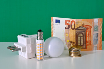 Light bulbs and coins for increasing electricity bills. Electricity prices rise, increasing the...