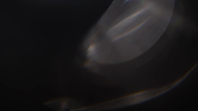 Optical glow lens flare bokeh transition overlays background. White lens flares Light Leak overlay on black background. Spherical Optical Light abstract background. Light Leaks footage