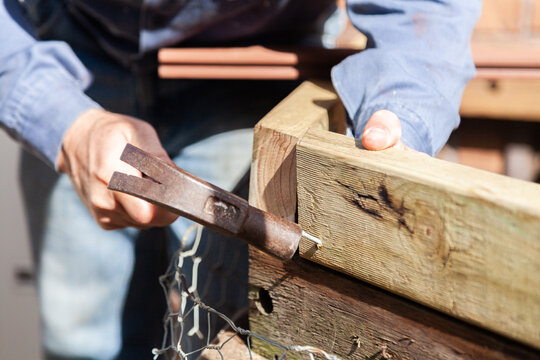 Man hammering nail into wood