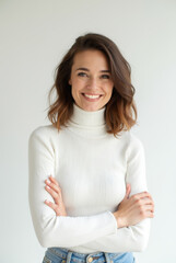 Obraz premium Smiling young woman in a white turtleneck, confident and friendly portrait with natural light