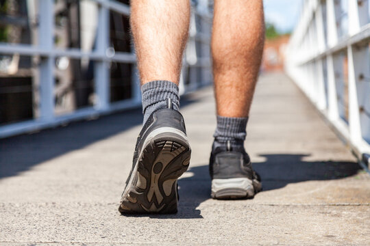 Close up of joggers shoes walking over bridge
