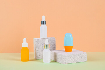 Plastic white tube for cream or lotion. Skin care or sunscreen cosmetic with stylish props on cream background.