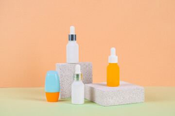 Plastic white tube for cream or lotion. Skin care or sunscreen cosmetic with stylish props on cream background.