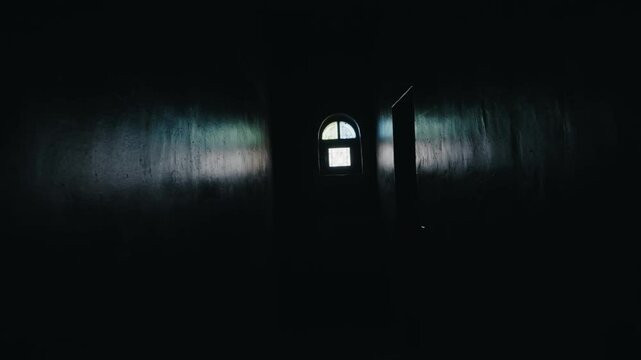 Dark hallway with a window at the end. Light shines through the window, creating a sense of hope. The hallway is empty and mysterious. Perfect for projects related to mystery, suspense, escape, hope.