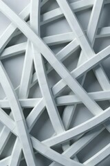 Obraz premium Interwoven white lines forming geometric shapes against a gray backdrop, composition, texture