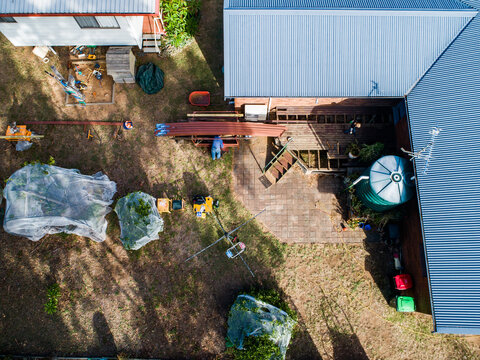 Backyard of home with worker building deck