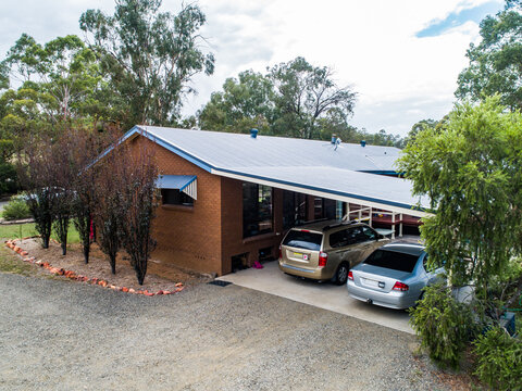 Family home with two cars parked in carport