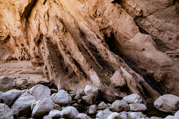 Water-sculpted rock formations in a canyon in the Middle East. Smooth, flowing shapes.