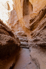 Winding slot canyon in Iran, the Middle East. Narrow passage with textured walls.