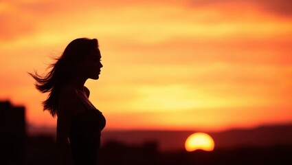 Fototapeta premium Silhouette of contemplative woman standing observing radiant sunset horizon