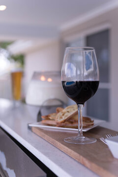 Glass of red wine and small plate of sourdough bread