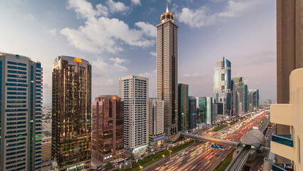 Downtown Dubai towers day to night timelapse. Aerial view of Sheikh Zayed road with skyscrapers...