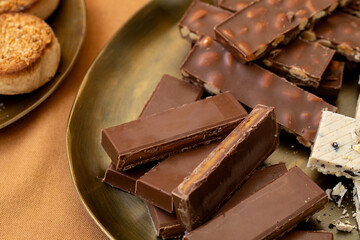 Christmas Spanish holiday treats, chocolate turron with whole almonds, creamy nougat, and polvorones