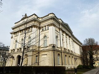 Ornate historic building facade surrounded by trees located in Warsaw, Poland