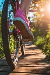 Naklejka premium A person rides a bike down a wooden path, with lush greenery surrounding the scene
