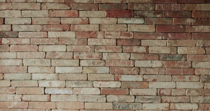Old brick wall of brown color in a modern apartment, damaged masonry as abstract background composition. textured surface of stucco texture with holes and scuffs. brick room, wall background.
