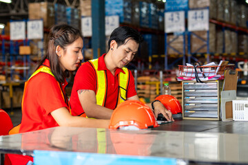Workers collaborate and manage tasks in a busy warehouse during daylight hours