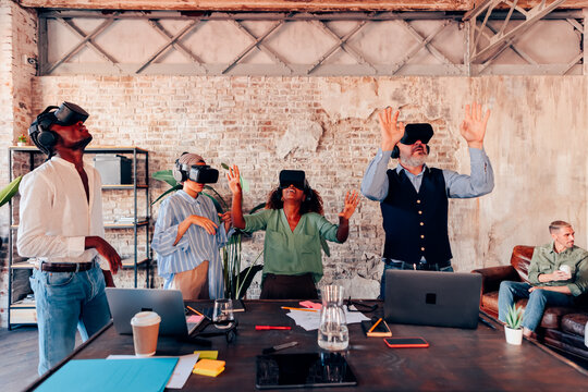 Diverse team experiencing virtual reality in office