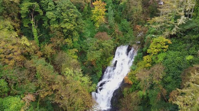 Flight over Torc waterfall near Killarney by autumn, Ireland