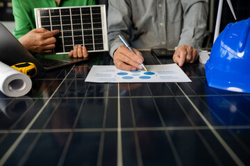 Two colleagues discussing data working green energy and solar panel concept.