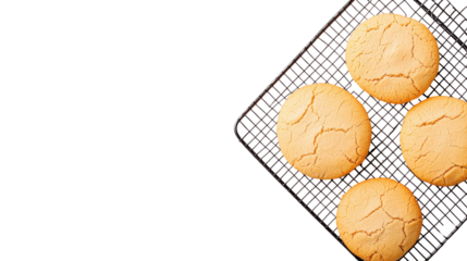 Freshly baked golden brown homemade pastries including cookies buns and other baked goods resting on a wire mesh cooling rack against a clean white background with copy space