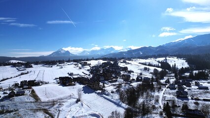 Murzasichle, Tatra Mountains, Poland. View of a mountain village near Zakopane during winter. In the background are the high Tatra Mountains, the peaks of which are covered with snow.  © Oliwia