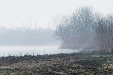 foggy landscape alon the Ticino river during a winter morning, Pavia