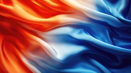 Obraz premium Vibrant silk fabric in orange and blue hues flowing elegantly, creating a dynamic and colorful backdrop for design