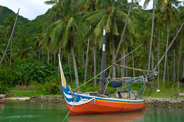 Karimunjawa island, Jepara regency, Central Java, Indonesia - June 11, 2017: A colourful traditional small fishing boats moored in a tropical island