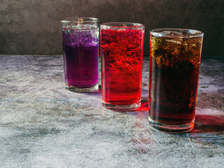 A lot of Soft drinks in colorful and flavorful glasses on the table,Glasses with sweet drinks with ice cubesv