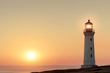 Lighthouse stands tall against a stunning sunset over the ocean creating a picturesque coastal view