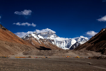 Fototapeta premium Breathtaking view of Mount Everest’s summit merging with the clouds, captured from Tibet. The world’s highest peak stands majestically, showcasing its grandeur and power