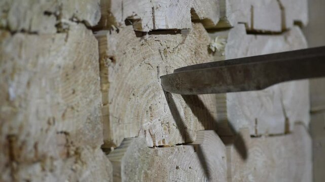 man throwing three metal knives in wooden block stand as target, throwing knives, sports competition, selective focus