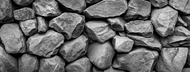 Fototapeta premium Detailed close-up of a black coal and sandstone rock pile, reflecting an industrial texture suitable for energy production themes