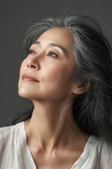 Fototapeta premium A woman with long black hair and a white shirt