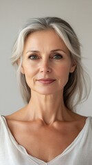 A woman with gray hair and a white shirt