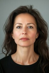 A woman with dark hair and a serious expression