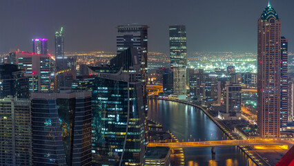 Naklejka premium Aerial skyline of Dubai's business bay with skyscrapers day to night timelapse