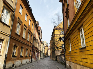 Colorful historic street view in Warsaw Poland with old architecture and paving