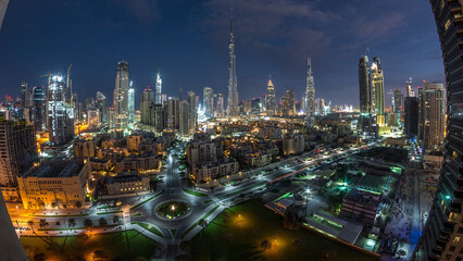 Fototapeta premium Dubai Downtown skyline night to day timelapse with Burj Khalifa and other towers panoramic view from the top in Dubai
