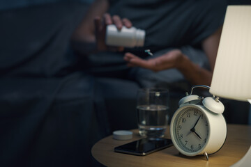 Young woman taking medications at night