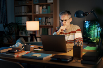 Man working late at night in his home office