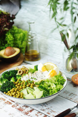 A bowl with a salad made of green vegetables