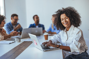 Smiling Professional at a Collaborative Business Meeting in Bright Office Space