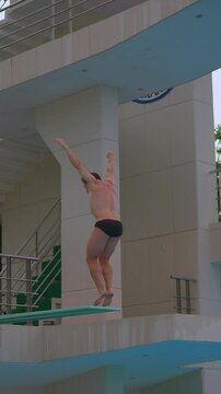 A professional athlete perfects his spring dive during training. The video showcases his dedication, technique, and athletic prowess as he practices each dive with precision and focus. Slowmotion