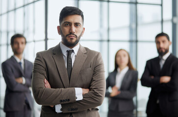 Fototapeta premium business team friendly group of four coworkers posing at office standing close together looking at camera
