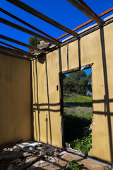 Abandoned House with Open Roof and Overgrown Entrance